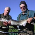 Rex Turpin (left) and Les Crosbie in 2011 with a  salmon moved  from the Hakataramea River to...