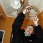 Rexel lighting specialist Chris Hartman replaces bulbs in the Luskie house. Photo by Linda Robertson