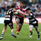 Rey Lee-Lo of Counties Manukau is tackled by Richard Buckman (R) and Zac Guildford of Hawkes Bay...