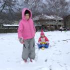 Rhian Sharman (7) and Emily Wellstead (3), both of Clyde, enjoy tobogganing in Clyde yesterday....
