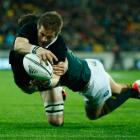 Richie McCaw dives over to score for the All Blacks against the Springboks. Photo Getty Images