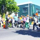 George Street Normal School principal Rod Galloway (left) supervises his pupils as they cross...