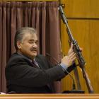 Robert Ngamoki, a police armourer, with the rifle used in the Bain murders, at the David Bain...