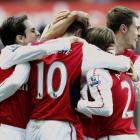 Robin van Persie (10) of Arsenal is congratulated after scoring against Swansea City during their...