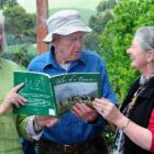 Robyn Handtschoewercker (left), Toby Martin, and Sharyn Kellas with a copy of Mr Martin's just...