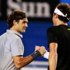 Roger Federer of Switzerland (L) shakes hands with Milos Raonic of Canada after defeating him in...