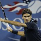 Roger Federer, of Switzerland, returns a shot to Robin Soderling, of Sweden, during a...