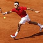 Roger Federer of Switzerland returns against Gael Monfils of France in their French Open...
