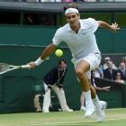 Roger Federer of Switzerland runs to hit a return to Mikhail Youzhny of Russia during their...