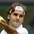 Roger Federer of Switzerland serves to Fabio Fognini of Italy during their men's singles match at...