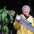 Roger Kan with his first salmon of the season, caught off Port Chalmers yesterday, and his "lucky...
