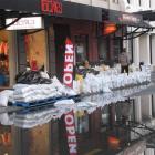 Rookies flies the open flag, reflected in the floodwater on Beach St. Photo by Tracey Roxburgh.