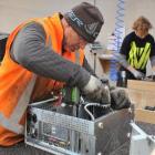 Ross Nicolaou (left) and Glen Drinkwater disassemble computers for recycling at Cargill...