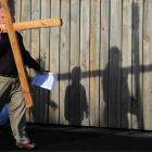 Rowley Scott carries the cross along Forbury Rd during the southern churches' Walk of the Cross...