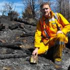 Rural Fire Officer Jamie Cowan holds one of the fireworks which caused the Queenstown Hill fire....