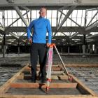 Russell Lund stands on the top floor of the Loan and Mercantile building after consent was...