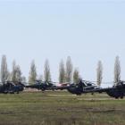 Russian military helicopters are seen in a field outside the village of Severny in the Belgorod...