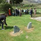 Ruth-Ann Anderson places rosemary on what were previously unmarked graves at the Glenorchy...