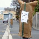 Sacks that appeared on parking meters and lights in the city yesterday, with messages critical of...