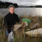 Saddle Hill Community Board chairman Keith McFadyen displays rubbish found in the Kaikorai...