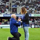 Sam Gilchrist goes down on one knee to propose to partner Ruth Jamieson at halftime during the...