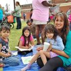 Samantha Martin (right) takes time out from her work at the Dream Center to hang out with some...