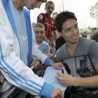 Samir Nasri signs autographs as he is greeted by fans outside Manchester City's Etihad Stadium in...