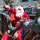 Santa Claus waves to the crowd during Oamaru's Christmas parade on Saturday. Photo by Sally Rae.