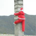 Santa inspects the chimney at Muzza's Bar and Restaurant in Wanaka.  Photo by Marjorie Cook