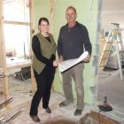 Sarah and Ross, the father and daughter team from Ross Andrew Builders, look over plans on one of...