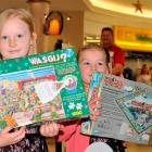 Sasha(left) and Olivia Barnes-Gardner, of Dunedin, place the first gifts under this year's...