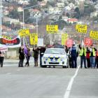 Save Hillside protesters are kept back by police during the opening of State Highway 88 in...