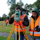 School of Surveying students (from left) Jeremy McCaffrey (20) and Eric Ko (21) work with a total...