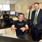 Scott Technology engineer Mike Diment shows Prime Minister John Key what he is working on, while...