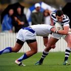 Sean Conner, of Otago Boys' High School, tries to charge through a tackle during his team's...