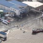 Seawater makes its way towards the city centre at a port in Kesennuma, northern Japan yesterday....