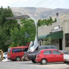 Sections of iron from the Bannockburn Hotel roof lie on top of parked cars yesterday.  Photo by...