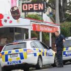 Senior Constable Andrew Marr talks to a colleague after a robbery at an Elgin Rd, Dunedin, dairy...