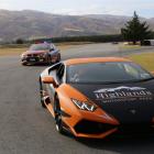 Senior Constable Graeme Buttar in his highway patrol car follows Highlands Motorsport Park owner...