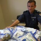 Senior Constable Graeme McPherson with some of the prescription medication seized by police...