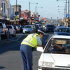 Senior Constable Toni Wall talks to the driver of a vehicle on King Edward St, South Dunedin,...