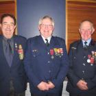 Senior station officer Ken Tisdall (centre) was Saturday evening honoured with the gold star...