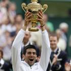 Serbia's Novak Djokovic lifts the trophy after defeating Spain's Rafael Nadal in the men's...