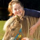 Shania Hutton gets  close to Honey, at Riding for the Disabled, where she is a volunteer. Photo...