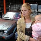 Sheree MacGillivray holds her 9-month-old daughter Lexia Burns as her car is tested at VTNZ. ...