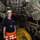 Shipboard geologist David Cox stands among some of the seismic scanning equipment aboard the...