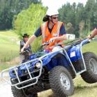 Showing how easy it is to tip a quad bike are tutors John Polstra (riding the bike), of Ag...