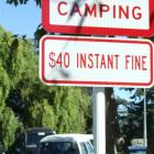 Signs such as this one at the One Mile reserve car park encourage tourists in campervans to be...