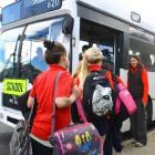 Silverstream School pupils board the Reid Park-North Taieri school bus as teacher Angela...