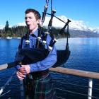 Simon McLean plays the McCallum bagpipes on the pier, sporting a McKewan clan kilt and most of...